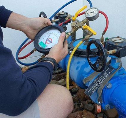 Worker inspecting Backflow - Plumber Pro Dallas