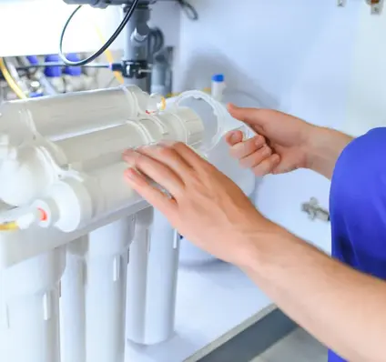 Worker changing Water Filter - Plumber Pro Dallas