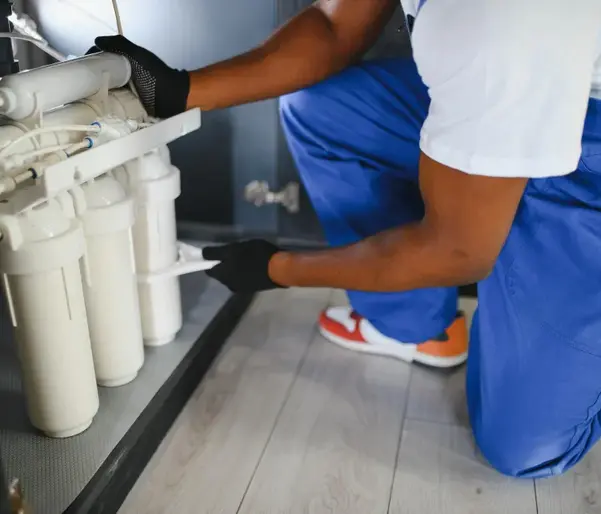 Worker installing Water Filtration - Plumber Pro Dallas