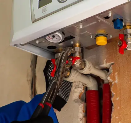 Worker fitting in Pipes with Heating Device - Plumber Pro Dallas