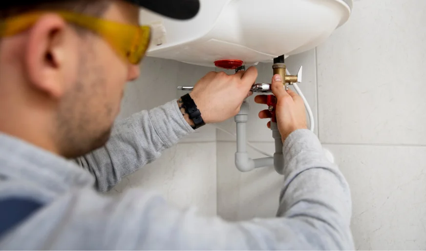 Plumber repairing water heater valve and connections – Plumber Pro Dallas